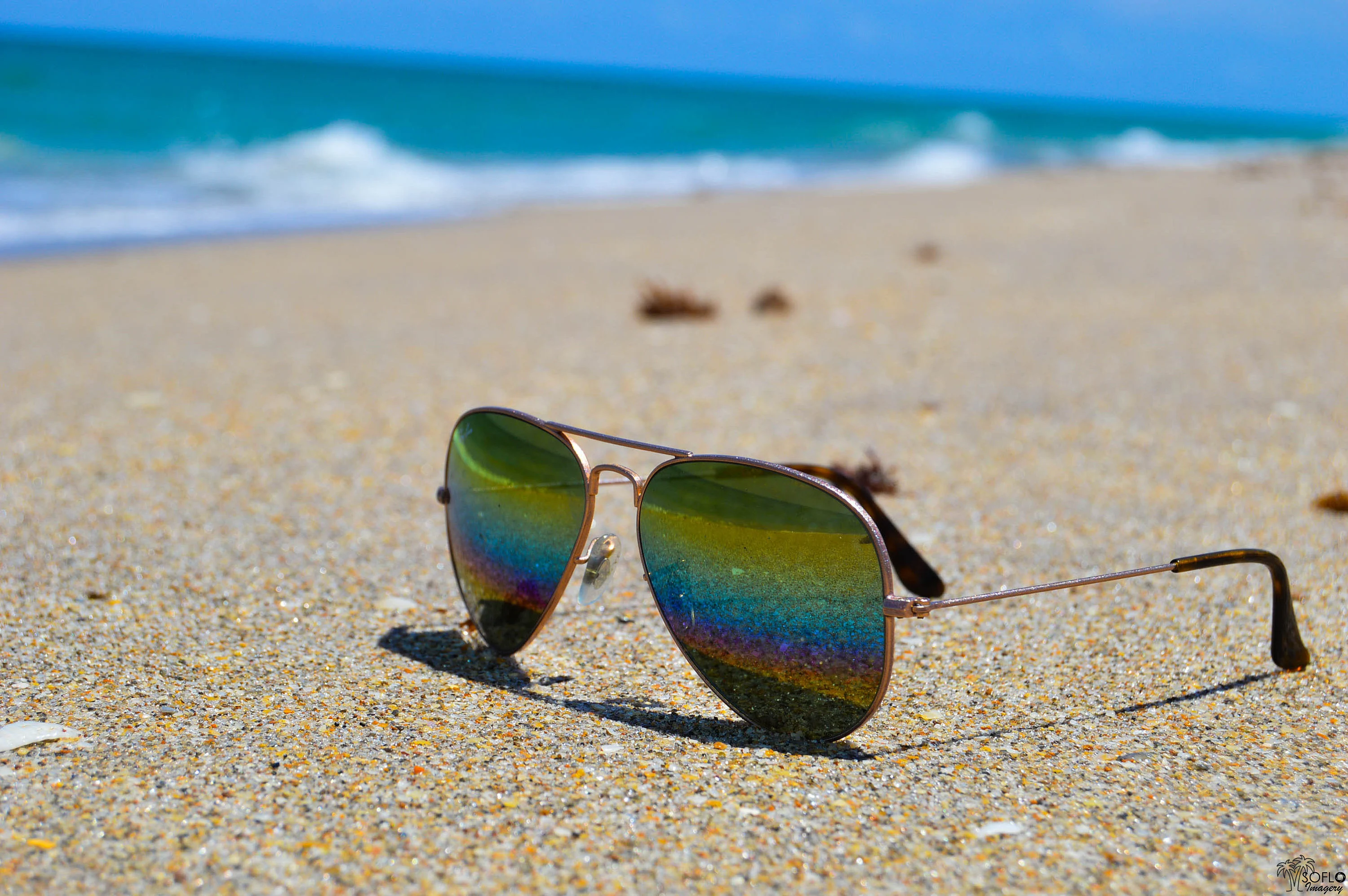 Pair of aviator glasses on sand