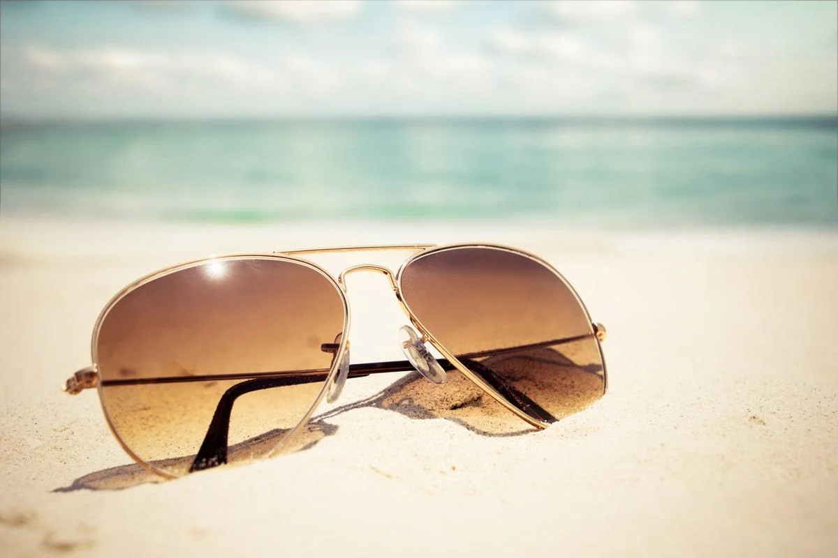 Pair of aviator glasses on sand